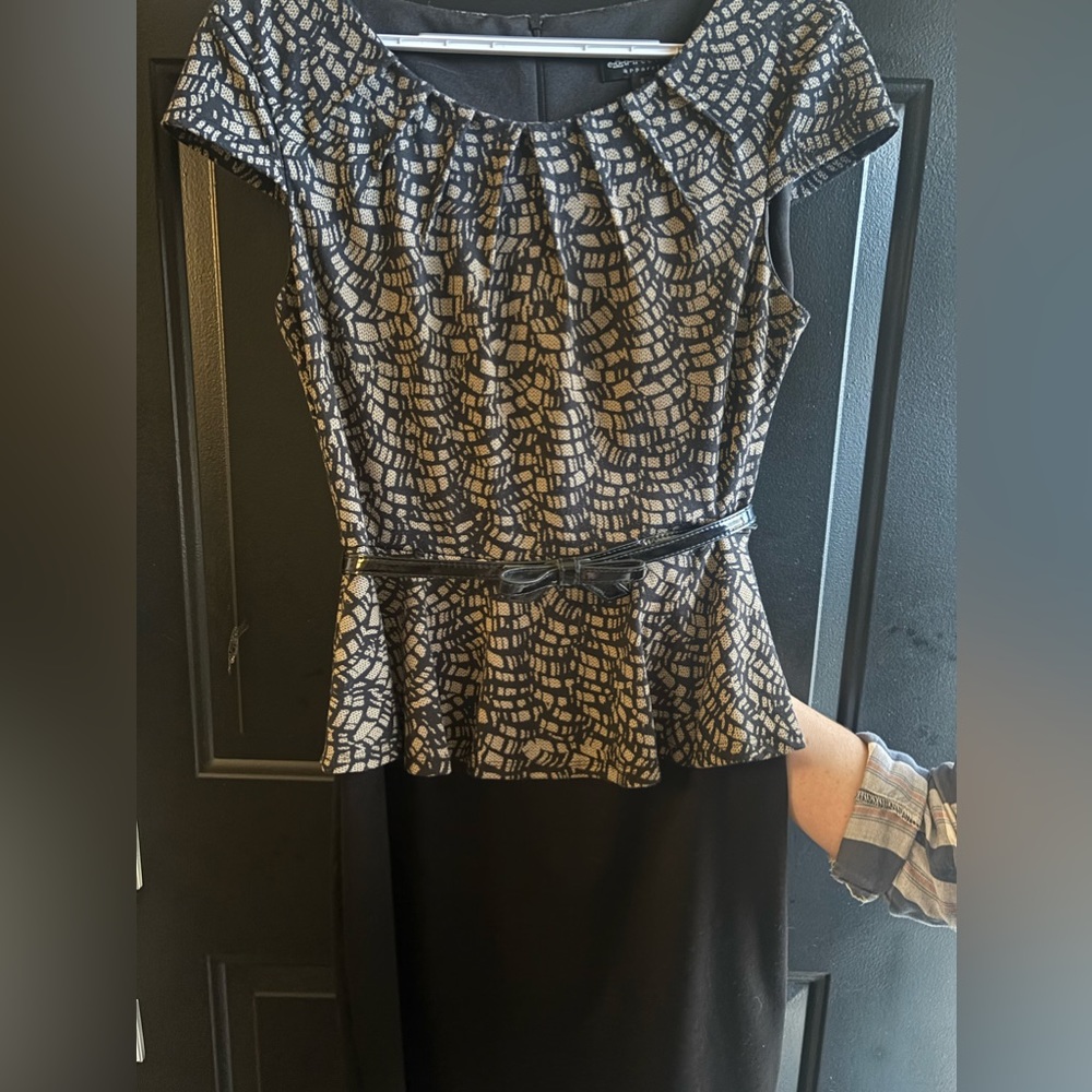 Black and brown dress with a belt.
